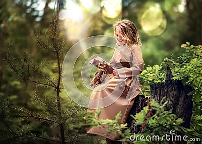 Girl playing with a live owl Stock Photo