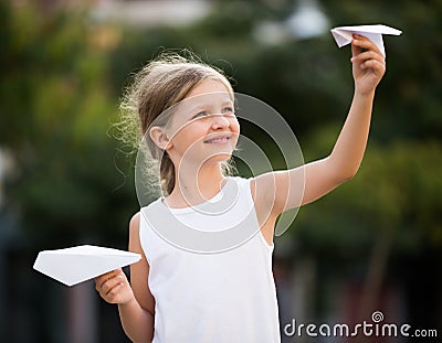 Girl playing paper airplanes Stock Photo