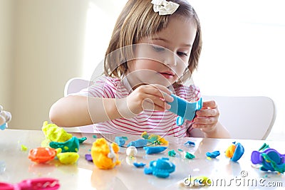 Girl playing with play dough Stock Photo