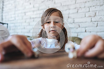 Girl playing with small figures sitting on soft Stock Photo