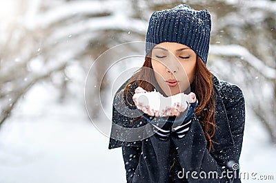 Girl playing with snow in park - close up portrait. Copy space Stock Photo