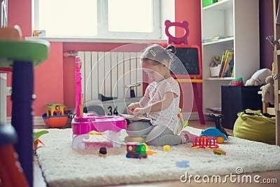 girl playing with toys in the children room Stock Photo