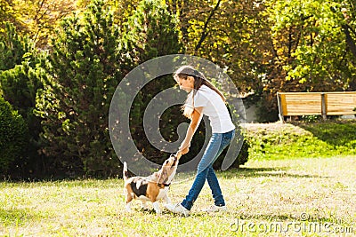 Girl plays with a dog in the yard Stock Photo