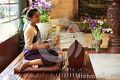 Girl plays in traditional gamelan instruments Editorial Stock Photo