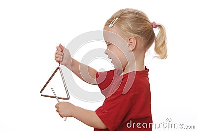 Girl plays triangle Stock Photo