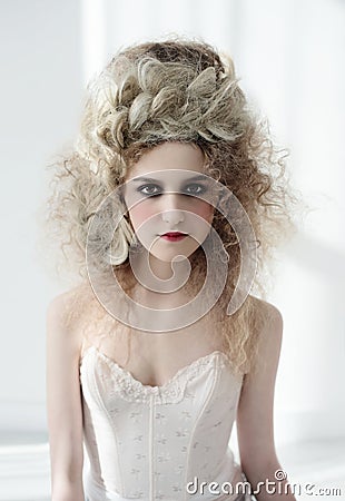 Girl in pompadour-style pompadour with a great haircut and a corset. Baroque and Rococo spirit. Stock Photo