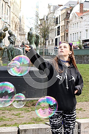 Girl popping bubble in Ghent, Belgium Editorial Stock Photo