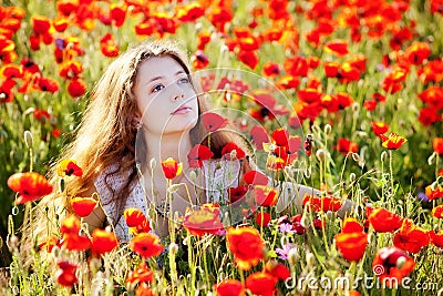 Girl on a poppy meadow Stock Photo