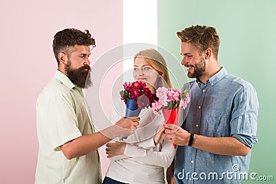 Girl popular receive lot men attention. Men competitors with bouquets flowers try conquer girl. Love triangle. Woman Stock Photo