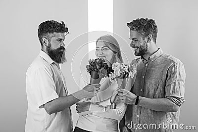 Girl popular receive lot men attention. Men competitors with bouquets flowers try conquer girl. Love triangle. Woman Stock Photo