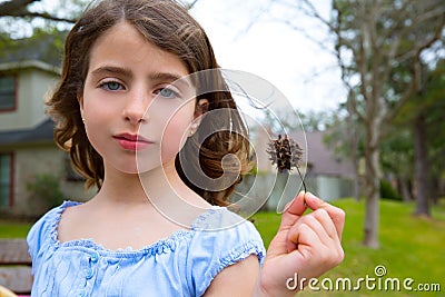 Girl portrait with sweetgum spiked fruit on park Stock Photo