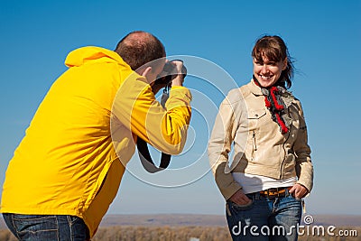 Girl poses for photographer on nature Stock Photo