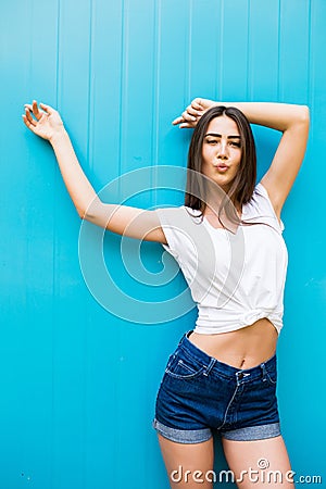 girl posing against blue colorfull wall background Stock Photo