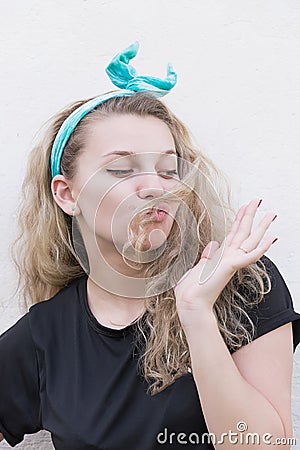 Girl posing against a white wall Stock Photo