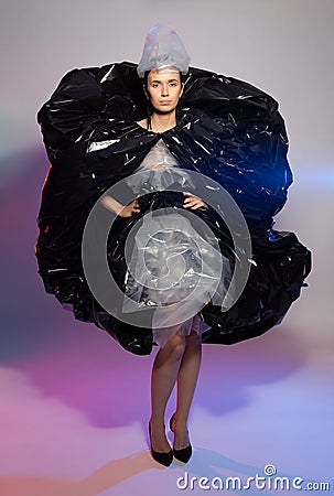 Girl posing in a dress made of plastic film. Fashion portrait. Stock Photo