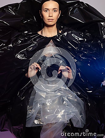 Girl posing in a dress made of plastic film. Fashion portrait. Stock Photo
