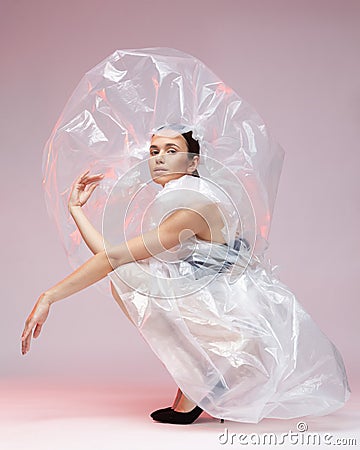 Girl posing in a dress made of plastic film. Fashion portrait. Stock Photo