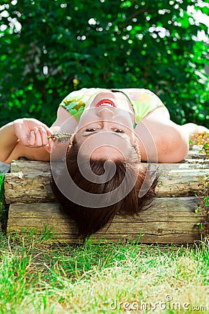 Girl posing in park on background of green Stock Photo