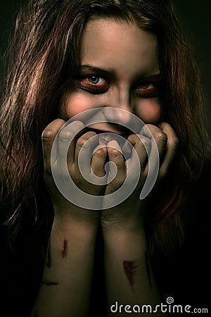 Girl possessed by a demon with a sinister smile Stock Photo