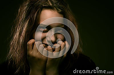 Girl possessed by a demon with a sinister smile Stock Photo