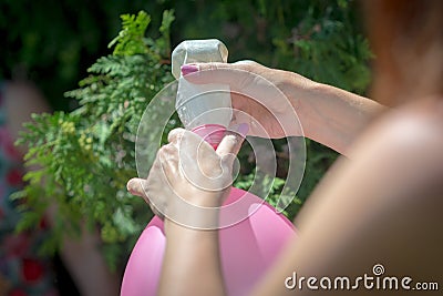 The girl pours flour into a balloon using a bottle Stock Photo