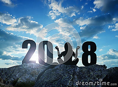 Girl practicing yoga on rock in the New Year 2018. Stock Photo