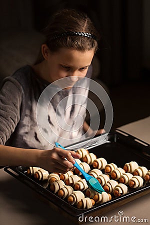 A girl prepares a dish of a pig in a blanket Stock Photo