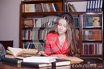 Girl is preparing for the exam in the library Stock Photo