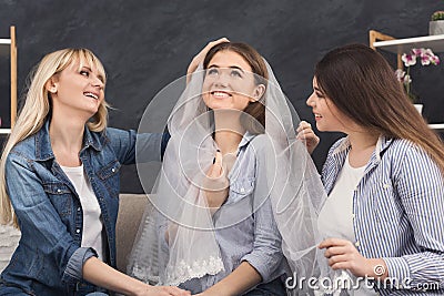 Girl preparing for wedding and showing bridal veil Stock Photo