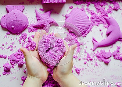 Kid`s hands with kinesthetic sand Stock Photo