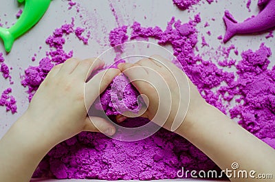Kid`s hands with kinesthetic sand Stock Photo