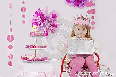 Girl with present at pink decoration birthday party Stock Photo