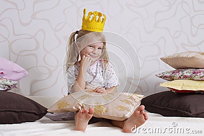 Girl in princess crown at pyjamas party Stock Photo