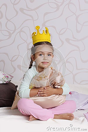 Girl in princess crown at pyjamas party Stock Photo