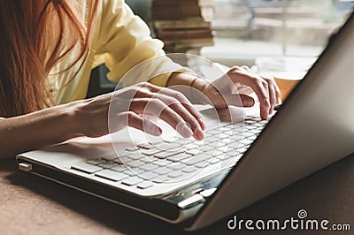 The girl prints on a white computer. Closeup of hands on the keyboard of a computer Stock Photo