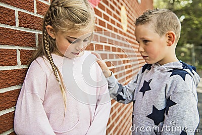 Girl problem at school, sitting and consoling child each other Stock Photo