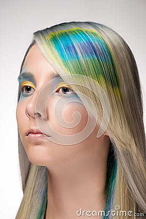 Girl with professional hair colouring and creative make up in peacock style Stock Photo