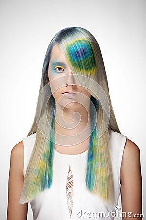 Girl with professional hair colouring and creative make up in peacock style Stock Photo