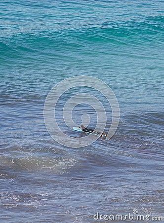 Girl ptracticing surf in Cala Major in Mallorca vertical Editorial Stock Photo