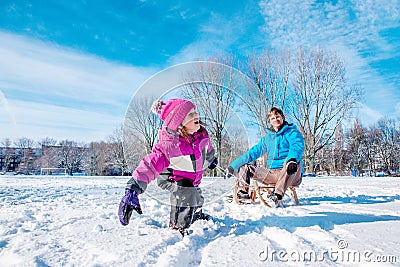 Girl pulling sledges Stock Photo