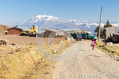 Girl pupil walking village road Bolivia mountains church building. Editorial Stock Photo