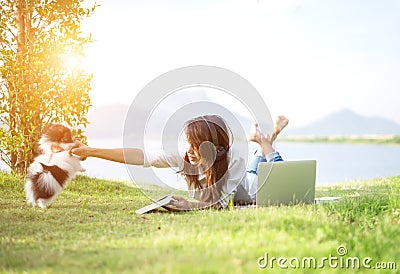 Girl and puppy dog enjoy listening music Stock Photo