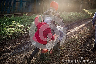 A girl pushes a bicycle with her older brother. Children of immigrants Stock Photo