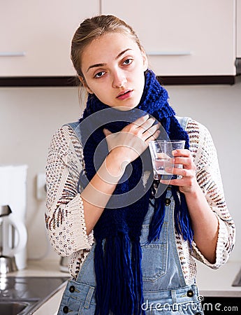 Girl with quinsy taking medicine Stock Photo