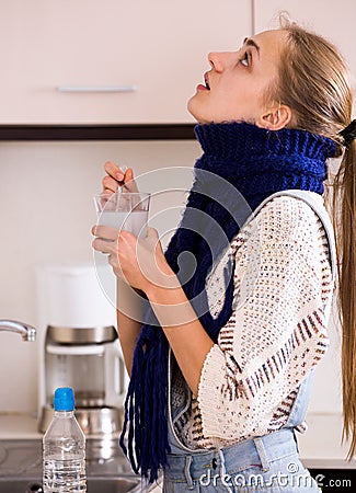 Girl with quinsy taking medicine Stock Photo