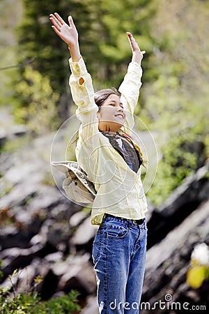 Girl raising hands in praise Stock Photo