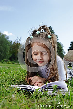 Girl read book on grass Stock Photo