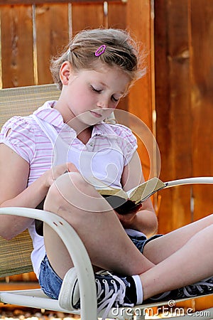 Girl reading bible Stock Photo