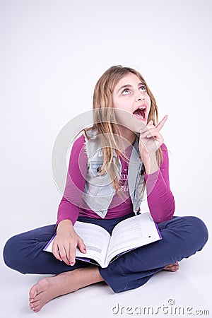 Girl reading a book and having an idea Stock Photo