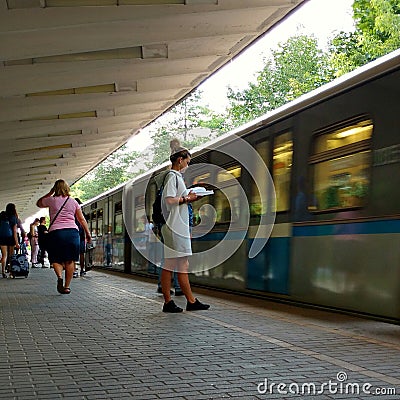 A girl is reading a book in the subway. Editorial Stock Photo